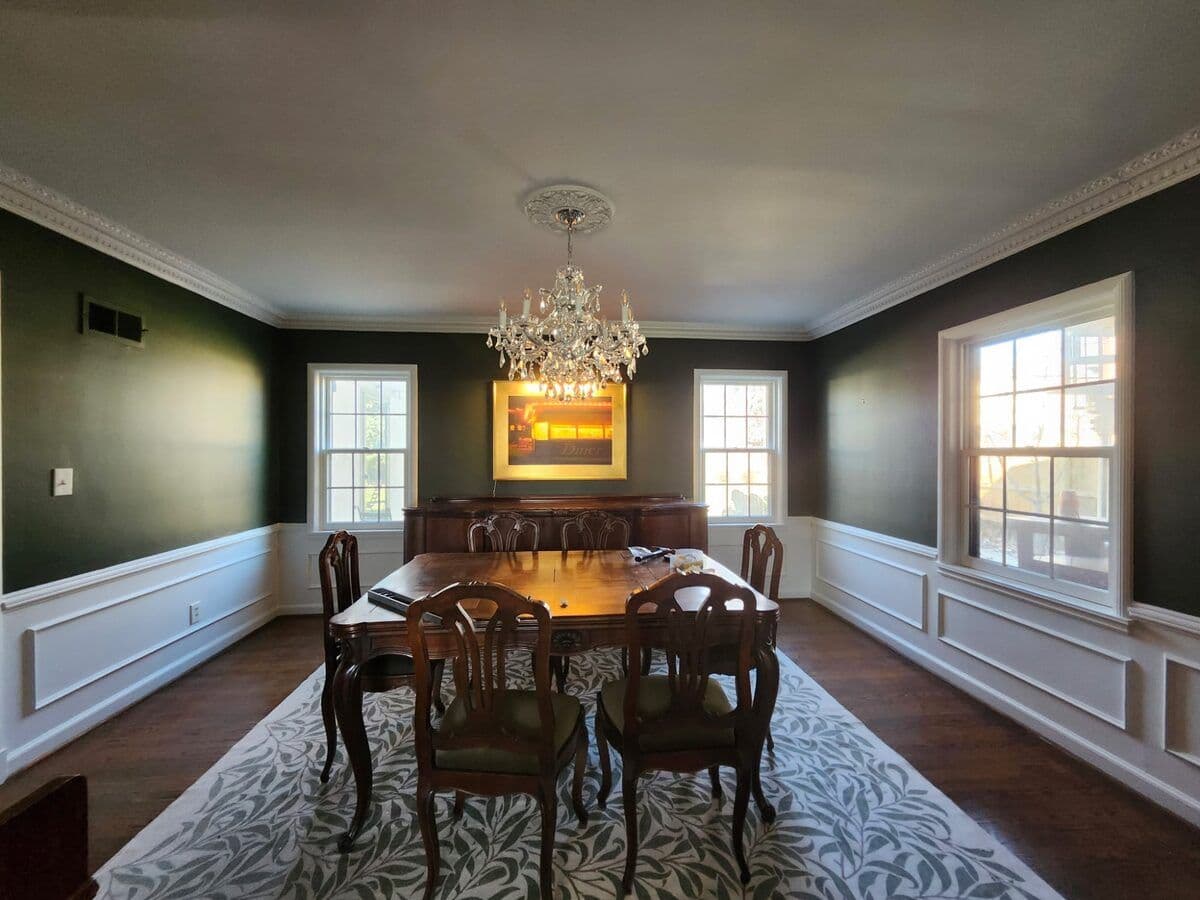 Dining room painted by Mission Painting showing green walls with white wainscoting and trim